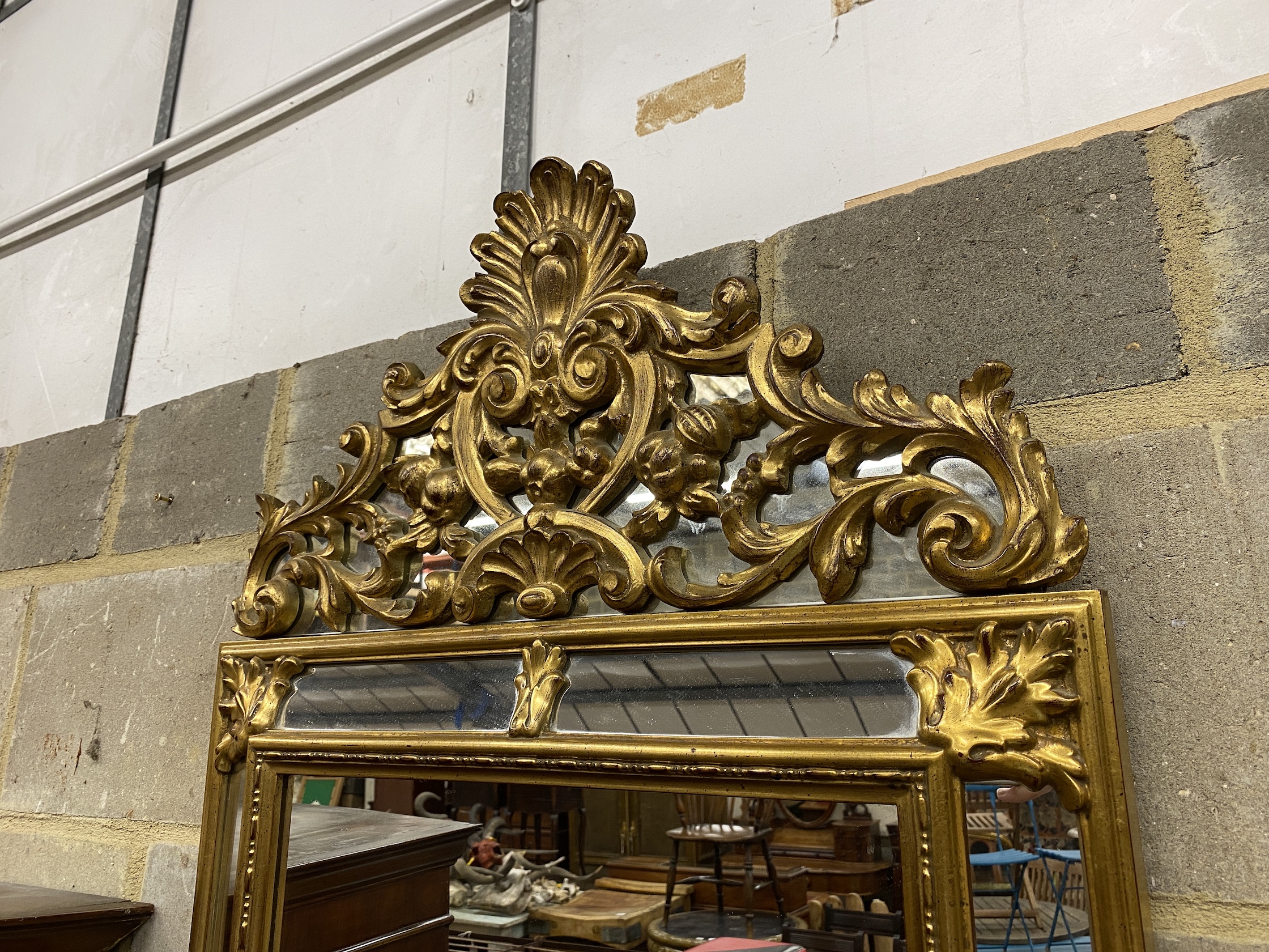 An 18th century style gilt composition wall mirror, width 62cm, height 106cm